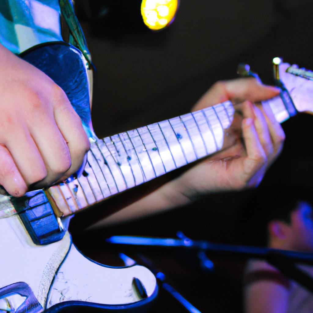 Person playing guitar on stage